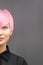 Woman with short bright pink hair