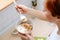 Woman with short ginger hair eating muesli with banana for a breakfast