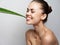 woman shoved a green aloe leaf into her mouth and bare shoulders clean skin