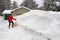 Woman shoveling snow from driveway