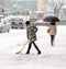 Woman shoveling winter snow in the city street