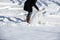 Woman shovelling snow to clear her driveway after winter storm