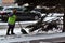 Woman shovels snow on sidewalk