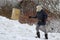 A woman shovels snow in winter. Snow shovels during snowfall