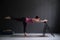 Woman show warrior asana using chair in studio background