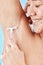 Woman, shower and shaving armpit skin for cleaning, skincare or hygiene with smile against blue background. Model