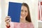 Woman showing a blank cover of a book