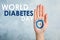 Woman showing blue circle drawn on palm against color background, closeup. World Diabetes Day