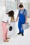 Woman Showing Damage In Washing Machine To Repairman