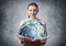 Woman showing earth globe in open book.