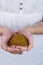 Woman showing handful of milled seed