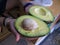 Woman showing huge fresh avocado in close up