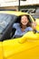 Woman showing sitting inside of her new sports car