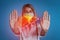 Woman showing stop gesture and illustration of unhealthy liver on blue background. Hepatitis disease