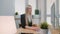 Woman showing thumbs down in office. Sitting at workplace young blond female in business suit looking at camera and