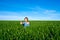 Woman showing thumbs up gesture in green field