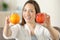 Woman showing two different fruits