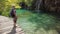 Woman showing waterfall in Plitvice Lakes National Park