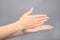 Woman showing word stop on grey background. Sign language