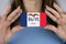 A woman shows a business card with an image of the Iowa flag