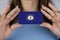 A woman shows a business card with an image of the Kentucky flag