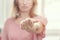 Woman shows contact lens at tip of outstretched finger. Optics, Vision, Optical Instruments