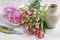 Woman shows how to make spring bouquet with tulip, hyacinth and carnation flowers
