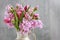 Woman shows how to make spring bouquet with tulip, hyacinth and carnation flowers