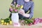 Woman shows how to make spring bouquet with tulip, hyacinth and carnation flowers, tutorial