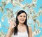 Woman shows ok sign. Dollar notes are falling down over blue background.