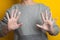 Woman shows soaped hands. Studio. yellow bright background, . hand disinfection to prevent coronavirus