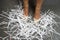 Woman with shredded paper at her feet
