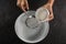 Woman sieving flour into the bowl