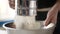 Woman sifting flour in a bowl