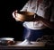 Woman sifting flour through sieve