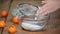 A woman sifting white flour. Home baking.