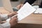 Woman signing employment agreement at table in office, closeup. Work contract