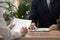 Woman signing employment agreement at table in office, closeup. Work contract