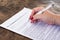 Woman signing employment contract on a marble table