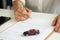 Woman signs contract for purchase of car on credit closeup