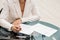 Woman signs document, emphasis on female hand and pen, supplying signature on official paper, signing name on statement with legal