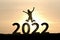 Woman silhouette on 2022 numbers. Happy new year 2022. Celebration concept. Beginning, Happy, enjoy, challenge