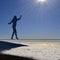 Woman silhouette balancing on a rope above the clouds