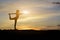 woman silhouette doing yoga outside the house in the evening