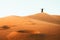 Woman silhouette enjoy sand dunes in desert in sunset blue hour alone. Travel lifestyle and wellness concept. Cinematic wanderlust