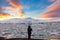 Woman in silhouette photographing the Glacier Lagoon in Iceland