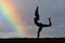 woman silhouette practicing yoga on the beach at sunset rainbow background illustration generative ai