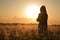 Woman silhouette waiting for summer sun