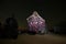 A woman in a silk dress looks at starry sky in a campground in the middle of the Erg Chebbi desert