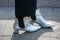 Woman with silver boots and polka dot trousers before Emporio Armani fashion show, Milan Fashion Week street